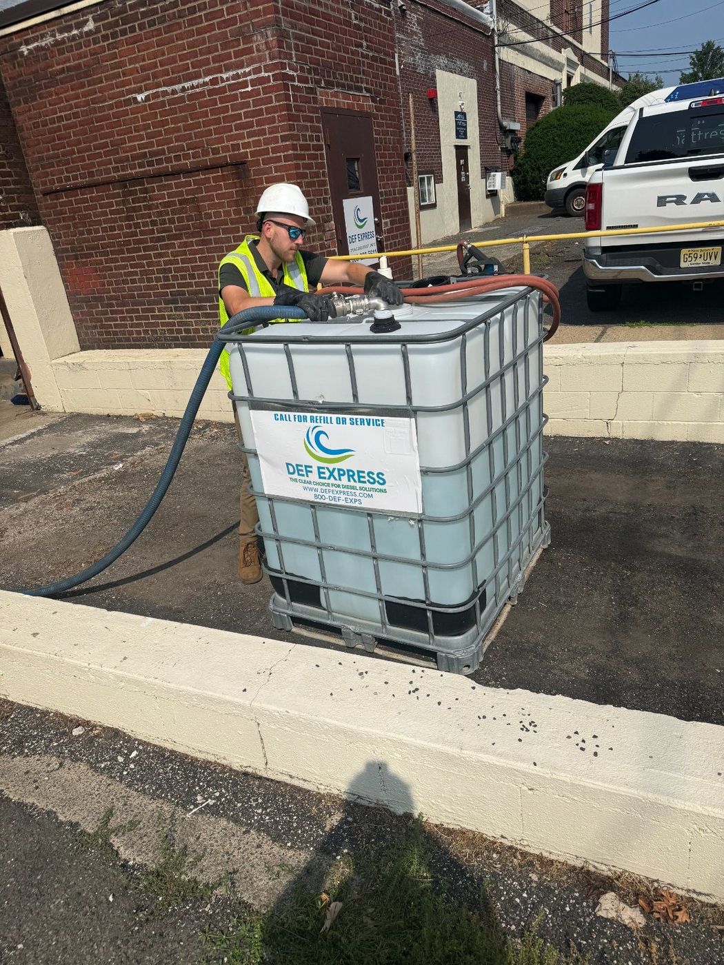 DEF Express technician refilling a 330-gallon DEF tote on-site